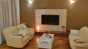 A living room with two sofas, a coffee table, and a fireplace.