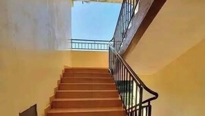 A staircase with a metal railing, leading to an upper floor. - Mountain view Spring (Nairobi)