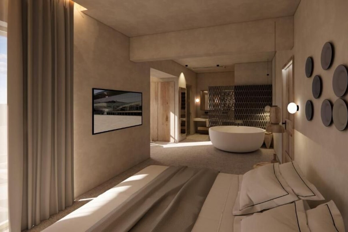Un baño moderno con una bañera grande, una zona de ducha y un lavamanos empotrado.