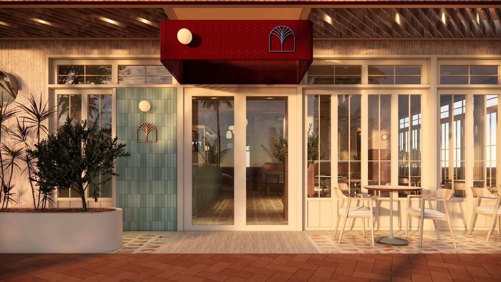 Un edificio moderno con toldo rojo, ventanas amplias y zona de estar al aire libre.
