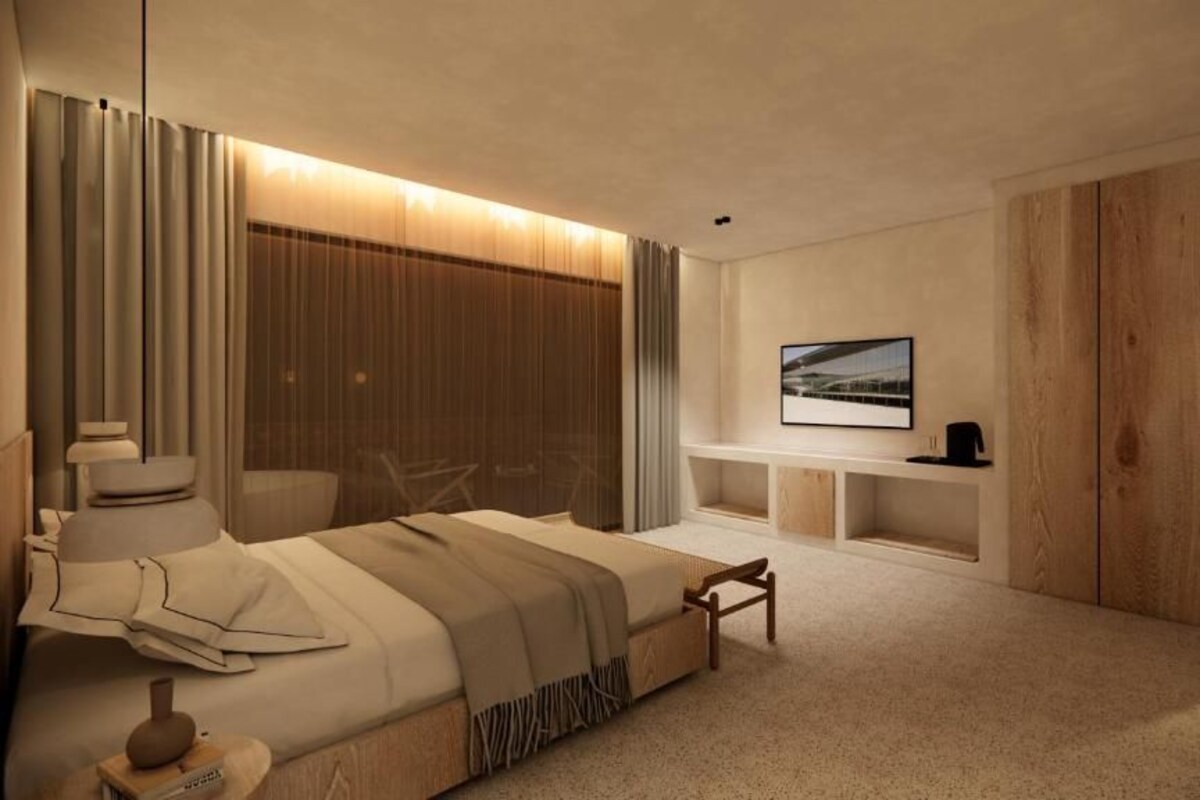 A modern bedroom with a large bed, bedside tables, a TV, and a wooden wardrobe.