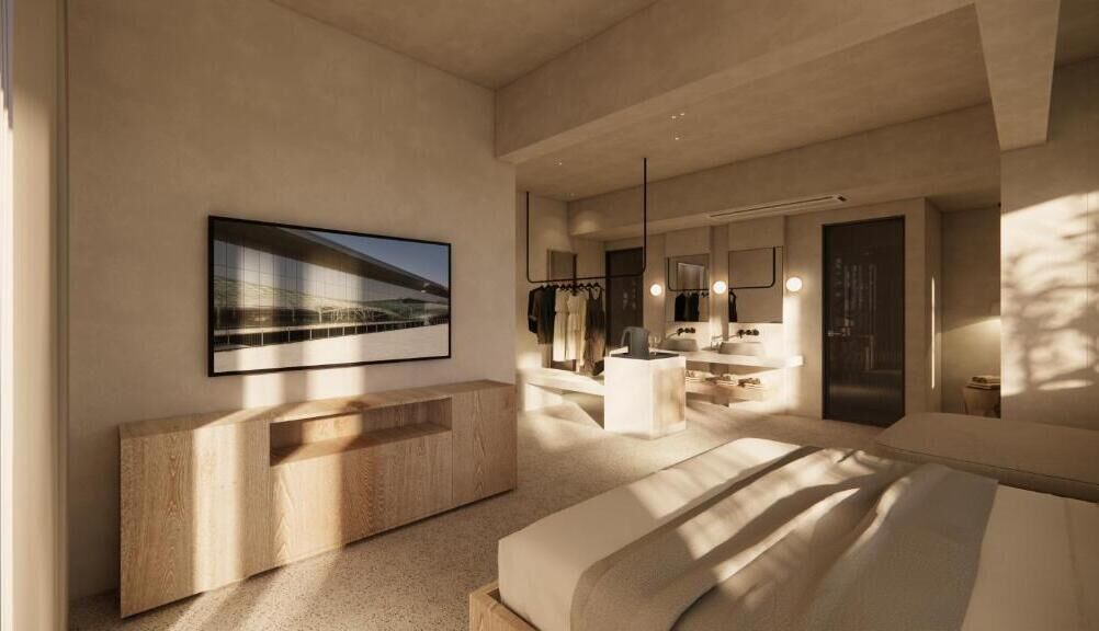Un dormitorio moderno con una cama grande, una consola de madera, un baño con espejo y lavamanos, y un cuadro enmarcado en la pared.