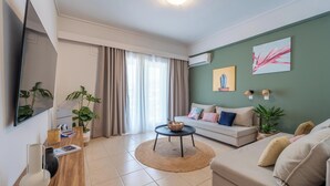 A living room with a sofa, coffee table, and a TV. - Residence City Frida (Rodos)