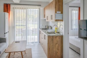 Apartment, Garden View | In-room safe, blackout drapes, iron/ironing board, free WiFi