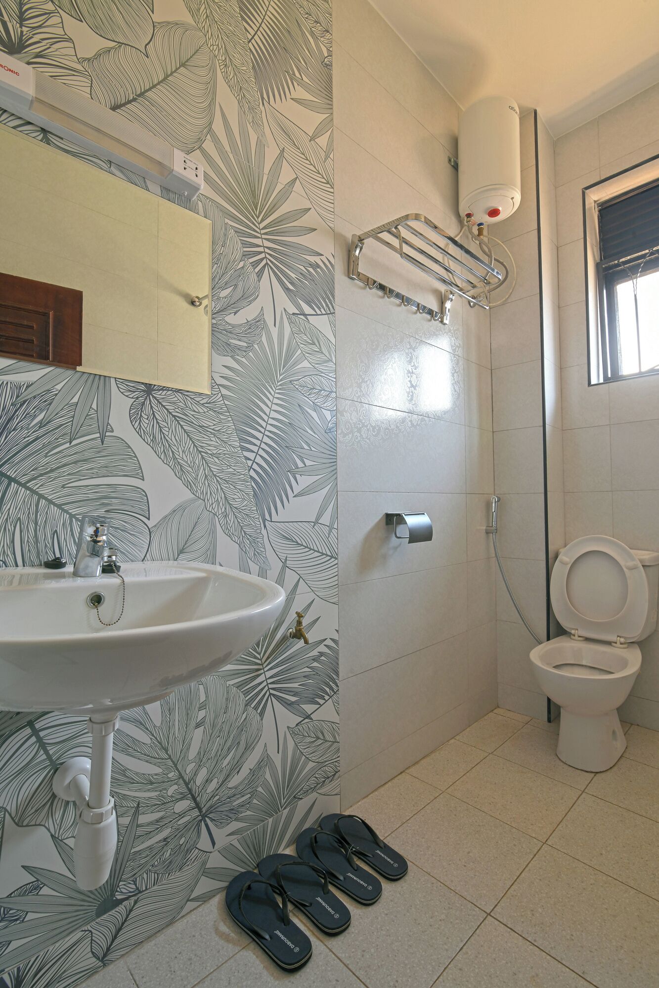 A bathroom with a sink, toilet, and shower.