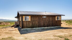 A rustic wooden cabin with a metal roof, a small porch, and a dirt ground. - 2 Mi to Big Hole River: Mtn-view Montana Haven (Twin Bridges)