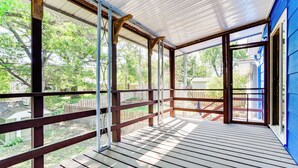 A covered porch with wooden railings and a view of the backyard. - 8 Mi to Central Minneapolis: Modern Home w/ Yard (Richfield)