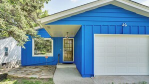 A house with a blue exterior, a white garage door, and a stone-paved driveway. - 8 Mi to Central Minneapolis: Modern Home w/ Yard (Richfield)