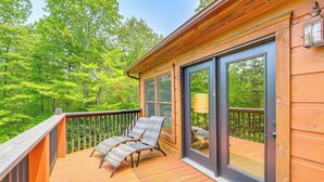 A wooden deck with two lounge chairs and a table, overlooking a forested area. - Blue Ridge Mtns Retreat w/ Views, 1 Mi to Parkway! (Hillsville)