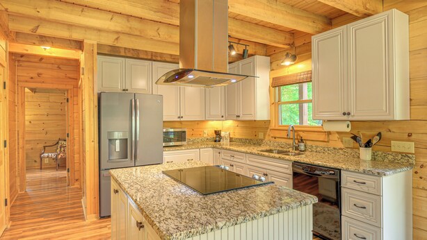 A modern kitchen with granite countertops, stainless steel appliances, and wooden cabinetry. - Blue Ridge Mtns Retreat w/ Views, 1 Mi to Parkway! (Hillsville)