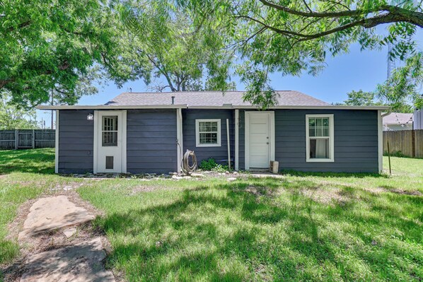 A two-story house with a front door, two windows, and a small porch. - Pet-friendly Home w/ 1-acre Yard in Aubrey (Aubrey)