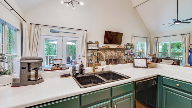 A kitchen with a coffee maker, sink, and green cabinets. - Fisher's Retreat Near Lake Thurmond: Tignall Home (Tignall)