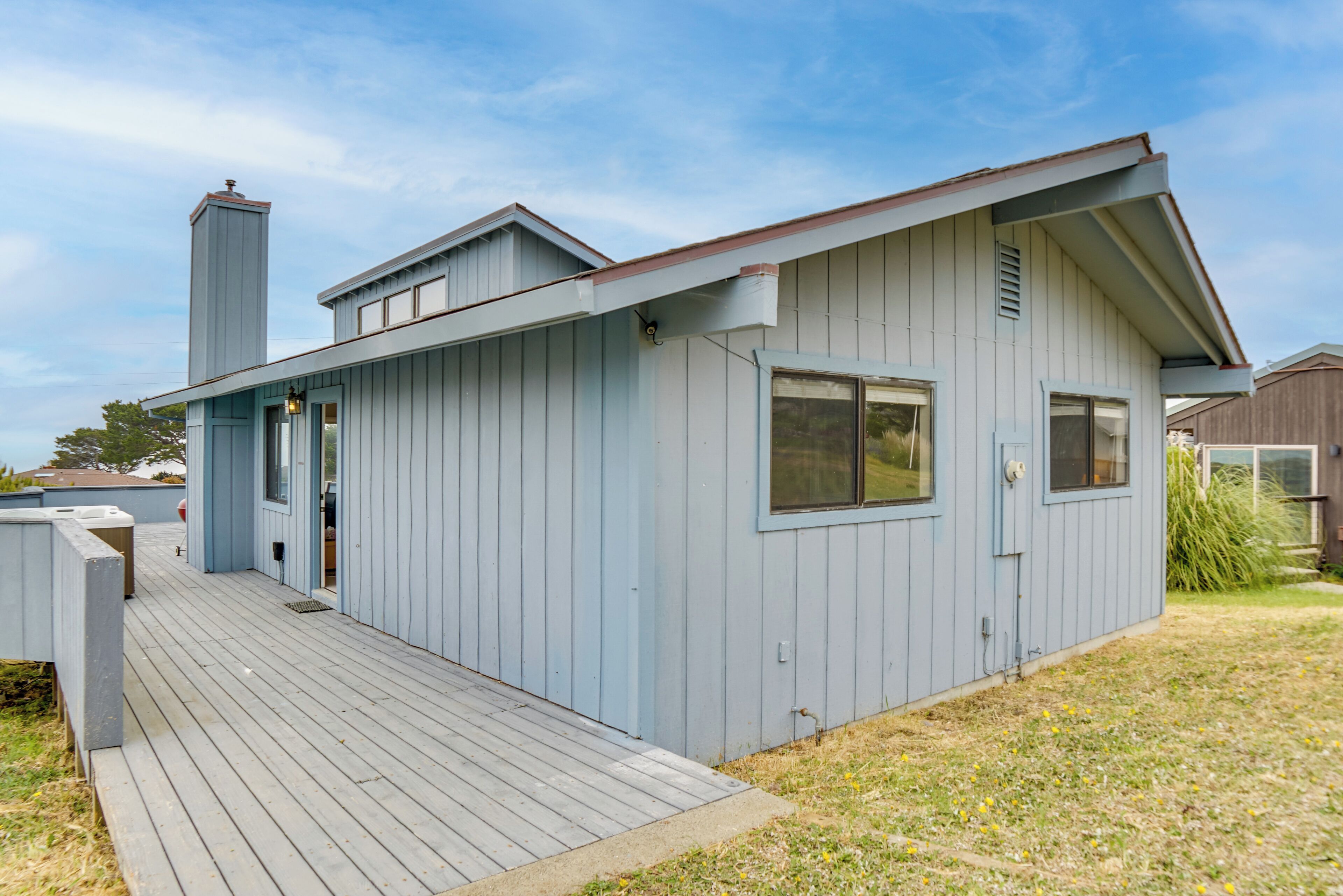 A single-story building with a flat roof, a chimney, and a front door.