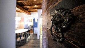 Un mur en bois orné d’une tête de lion en métal servant de heurtoir.
