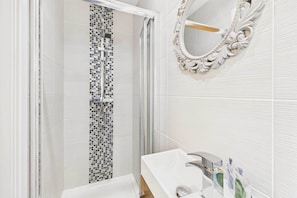 Shower, hair dryer, towels, shampoo