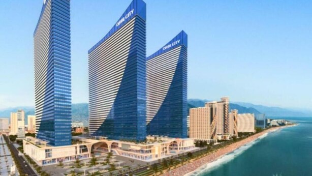 A modern hotel with two prominent skyscrapers, a waterfront promenade, and a marina. - Orbi Panorama Sea Resort (Batumi)