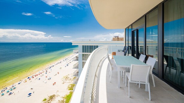 A balcony with a view of a beach and ocean. - Phoenix Gulf Shores Ii 2001 4 Bedroom Condo (Gulf Shores)