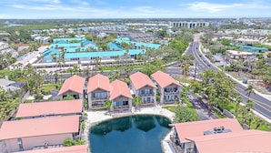 A coastal hotel with multiple buildings, a marina, and a road leading to the city. - Siesta Beach Retreat 2 Bedroom Townhouse (Siesta Key)