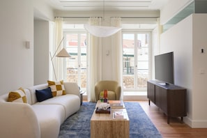 Deluxe Duplex | Living area | 50-inch flat-screen TV with cable channels