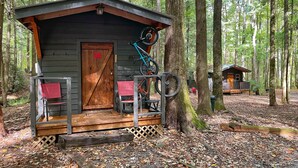 A cabin with a porch, a door marked '3A', and bicycles mounted on the wall.