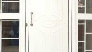A white door with a handle and a small window above it. - Petralona Antistratou Athens (Athens)