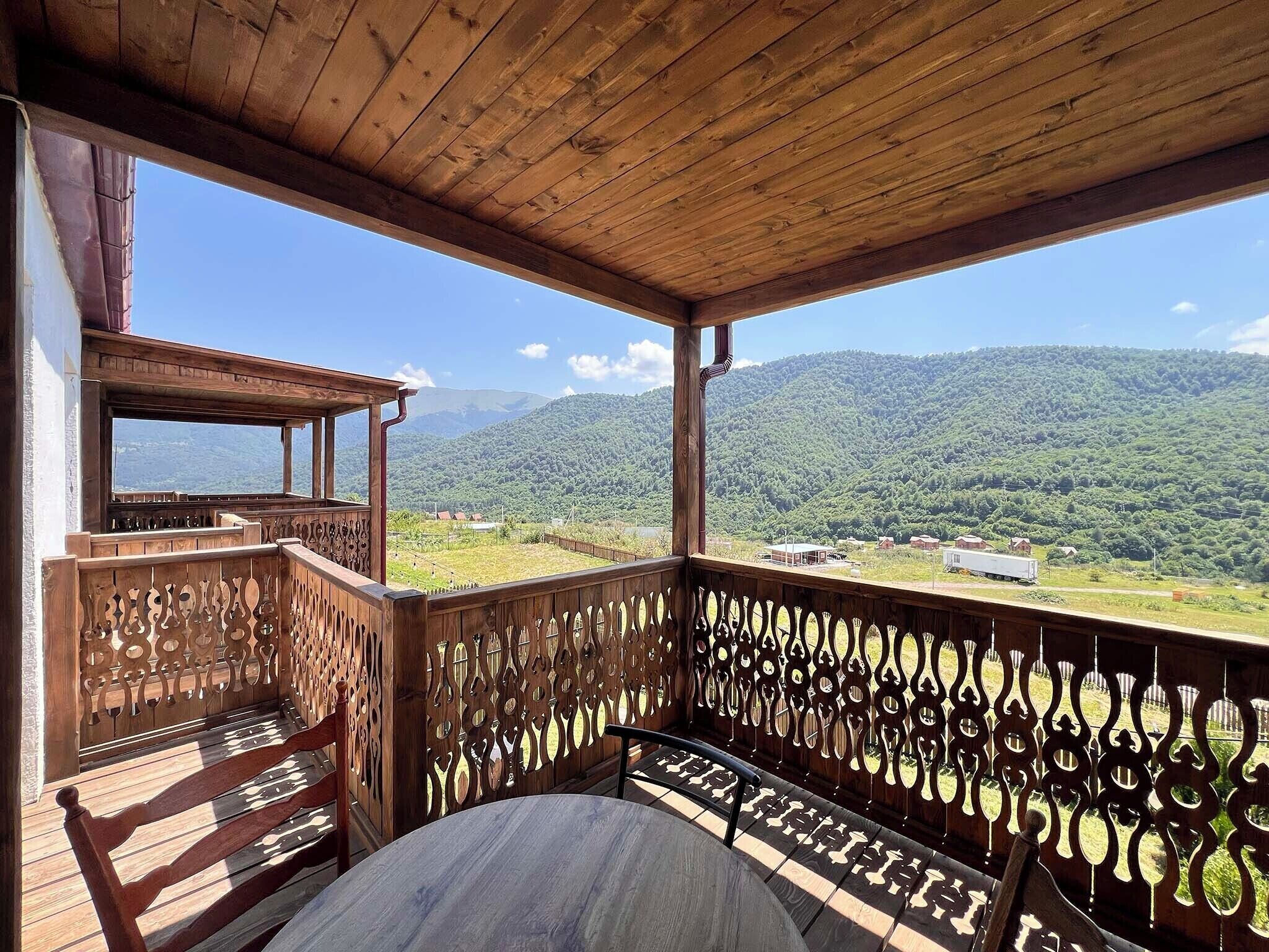 A wooden deck with a view of a mountainous landscape.
