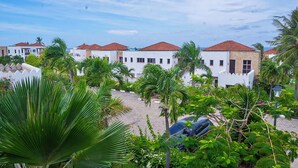A residential area with white buildings, red roofs, and lush greenery including palm trees. - Serene 2bedroom Beach Apartment, Sultanpalace Kikambala. Northcoast Kilifi Kenya (Kikambala)