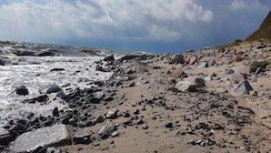 A rocky beach with waves crashing onto the shore. - 6 Person Holiday Home in Gedser (Gedser)