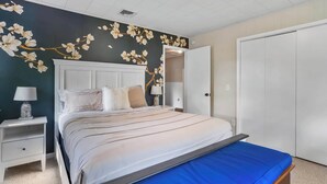 A bedroom with a bed, nightstands, a dresser, and a wardrobe. - Waterfront Hot Tub Retreat w Kayaks | Kayak Point (North Fork)