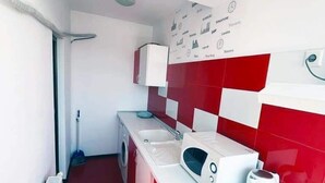 A compact kitchen with a microwave, kettle, and sink. - Luxorvilla studios (Constanta)