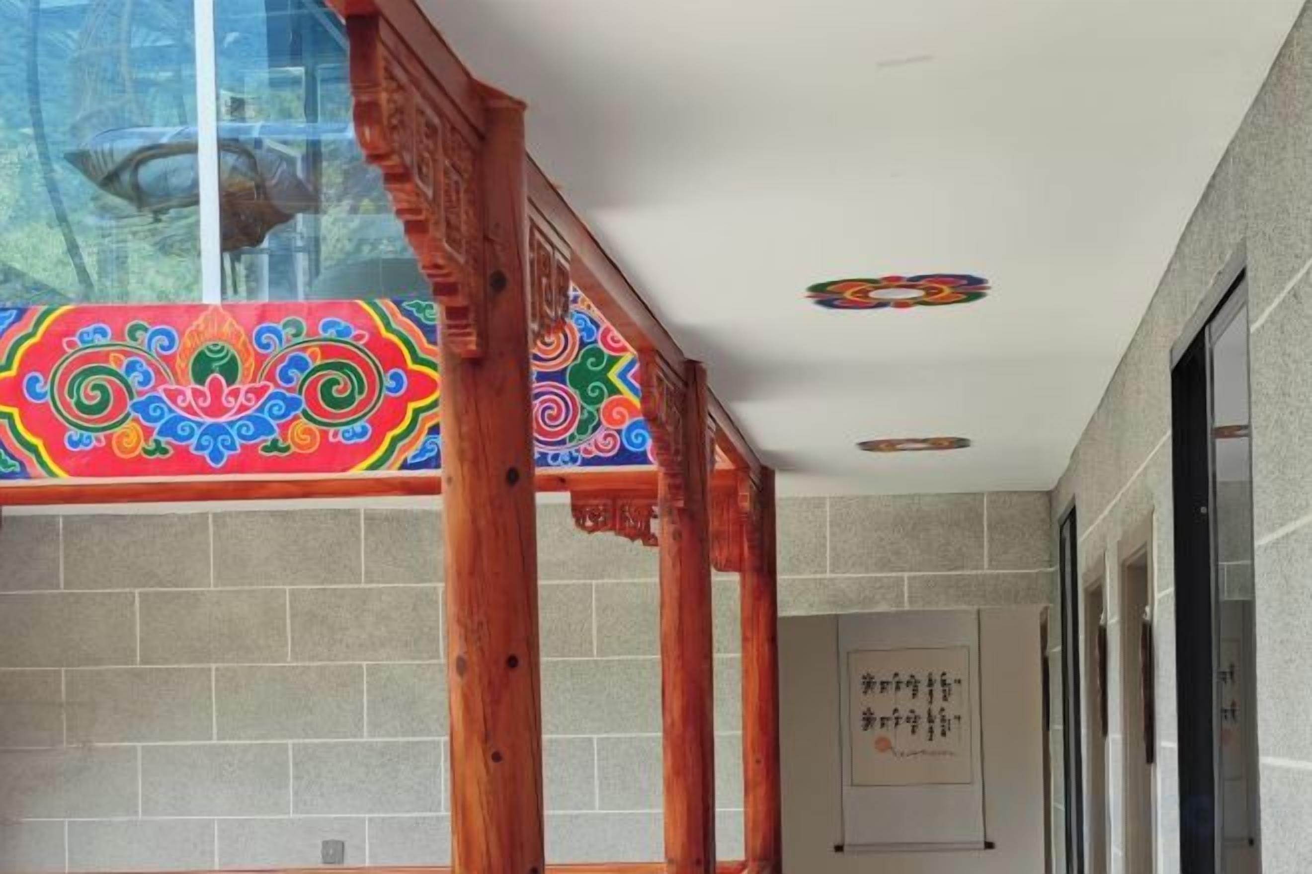 A corridor with a wooden structure, tiled walls, and a ceiling with decorative elements.