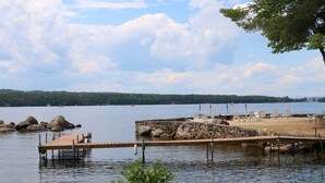 A lakeside dock with chairs and a stone wall. - Lakeside 2-bedroom w/ AC sleeps 5. Quiet Beach in lovely Naples. (Naples)