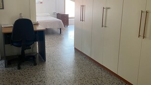 A bedroom with a bed, a desk with a chair, and a wardrobe. - Near the sea central location, attic 3 floor elevator climate. (San Benedetto del Tronto)