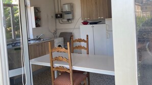 A compact kitchen with a dining area, including a table and chairs, a washing machine, and a sink. - Near the sea central location, attic 3 floor elevator climate. (San Benedetto del Tronto)