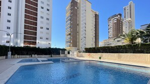 A swimming pool surrounded by high-rise residential buildings.