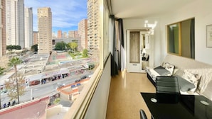 A balcony with a city view, a sofa, a small table, and a door leading to another room. - NEW TOWN LEVANTE BEACH (N121) (Benidorm)