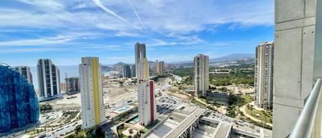 A high-rise urban area with modern buildings, a road, and greenery.