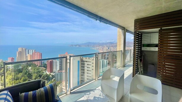 A balcony with a city view, white chairs, and a sofa. - MIRADOR DEL MEDITERRANEO N172 (Benidorm)
