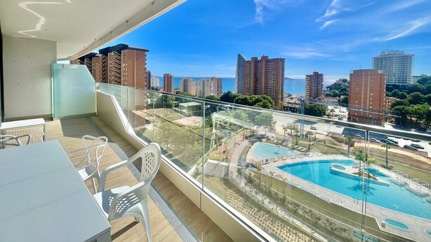 A balcony with a view of a cityscape and a swimming pool. - LUXURY BENIDORM BEACH PONIENTE N107 (Benidorm)