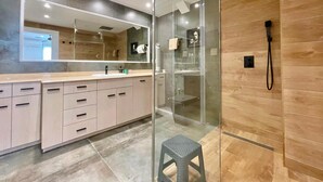A modern bathroom with a glass shower enclosure, a large mirror, and a vanity with multiple drawers. - EMALCO SEAFRONT MODERN APARTMENT A061 (Benidorm)