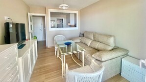 A compact living space with a kitchenette, a dining area with a glass table, and a sofa. - ALBAIDA PARK BENIDORM LEVANTE (A137) (Benidorm)