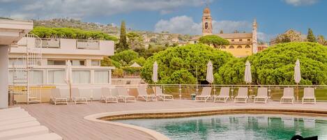 Alberca al aire libre por temporada y sombrillas en la alberca