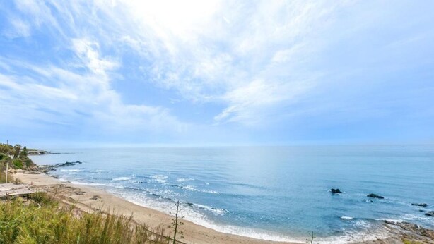 A beach with clear skies and calm waters.