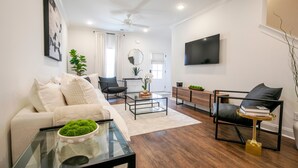 A modern living room with a sofa, coffee table, and chairs. - The Hurley, 3BR Luxe Townhouse by VelvetDitchVillas (Oxford)