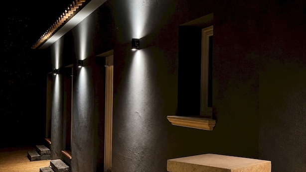 A building exterior at night with illuminated columns, a window, and a stone staircase. - Villa w/ pool in Begur (H14) (Begur)