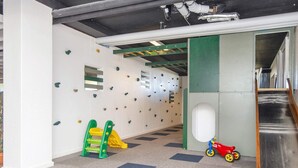 A children's play area with climbing walls, a slide, and a small red toy car. - 4 Person Holiday Park Home in Fano (Fano)