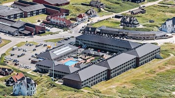 A large building with multiple sections, including a swimming pool area.