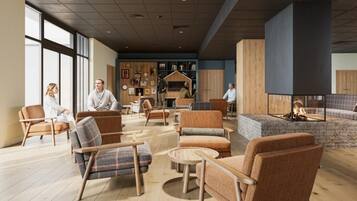 A spacious lobby with multiple seating areas, a fireplace, and a wall adorned with various artworks.