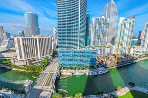 A modern hotel with a curved facade, located by a waterfront with boats docked nearby. - Icon Brickell  (Miami)