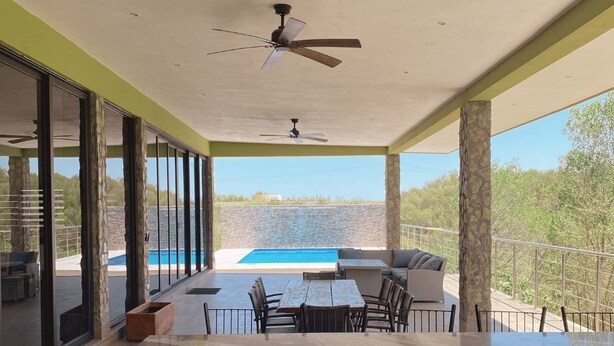 A modern outdoor patio with a pool, seating area, and a view of the water. - Rancho Florean - Villa 3 (Montemorelos)